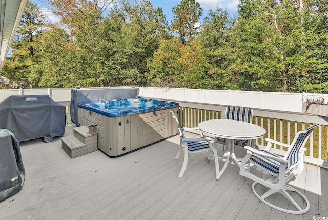 wooden terrace featuring a hot tub and grilling area