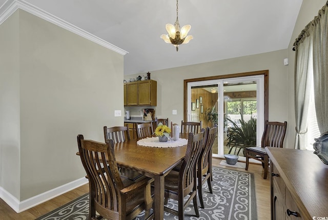 153 Garden Ave, Georgetown, SC 29440 - dining area featuring light wood-type flooring, a chandelier, baseboards, and ornamental molding