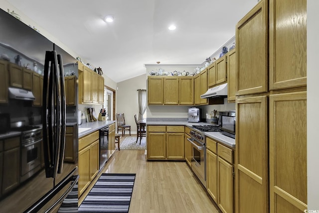 153 Garden Ave, Georgetown, SC 29440 - kitchen with stainless steel range, under cabinet range hood, vaulted ceiling, light countertops, and light wood-style flooring
