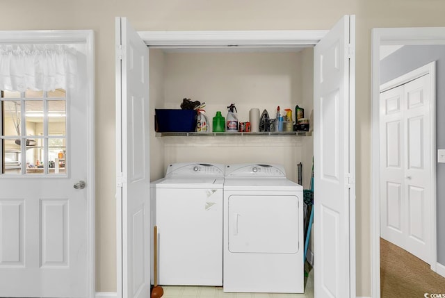 clothes washing area with washing machine and dryer and light carpet