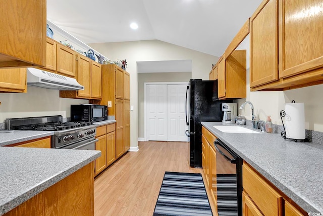 kitchen with sink, black appliances, beverage cooler, lofted ceiling, and light wood-type flooring