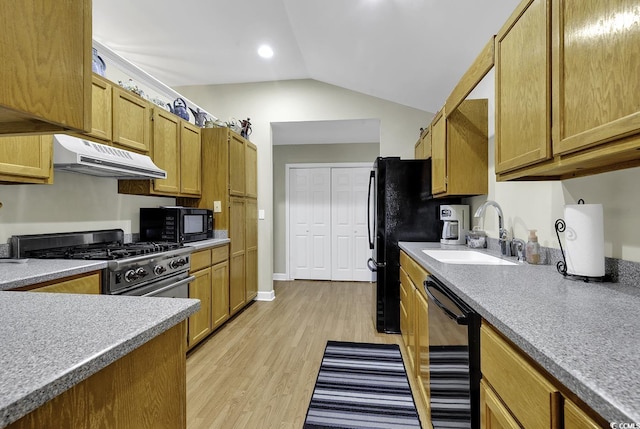 153 Garden Ave, Georgetown, SC 29440 - kitchen with under cabinet range hood, black appliances, a sink, light wood-style floors, and lofted ceiling