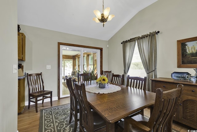 153 Garden Ave, Georgetown, SC 29440 - dining space featuring vaulted ceiling, a chandelier, healthy amount of natural light, and wood finished floors