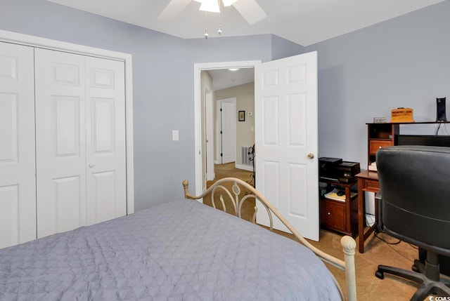 carpeted bedroom with a closet and ceiling fan