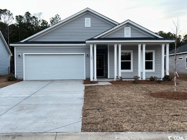 view of front of property featuring a front lawn and a garage