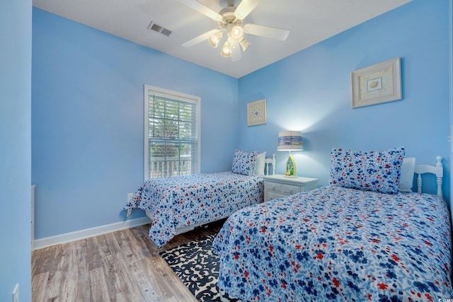 bedroom with ceiling fan and hardwood / wood-style flooring