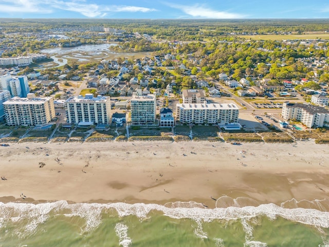 bird's eye view with a water view and a beach view