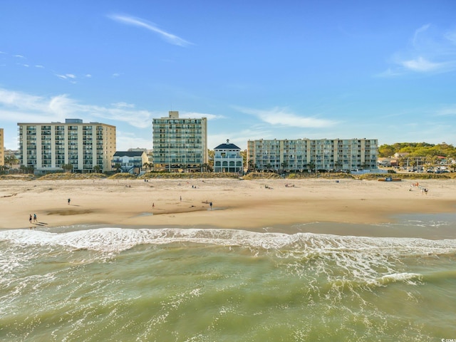 birds eye view of property featuring a beach view and a water view