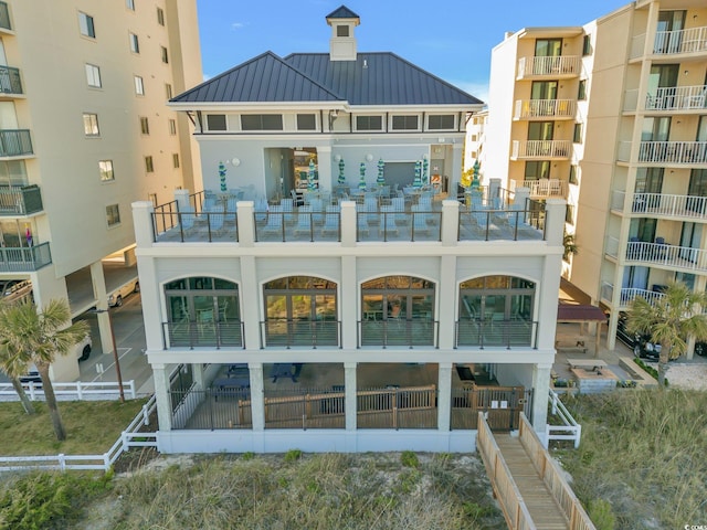 rear view of property with a balcony