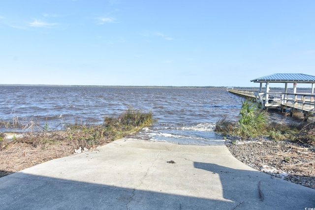 view of dock with a gazebo and a water view