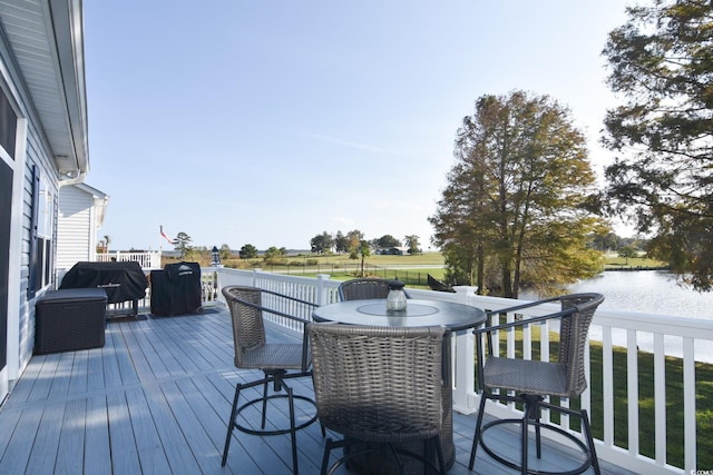 wooden deck featuring grilling area and a water view