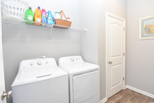 laundry room featuring dark hardwood / wood-style floors and washer and dryer