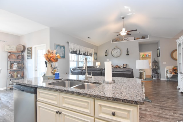 kitchen with dishwasher, light stone countertops, a kitchen island with sink, and sink