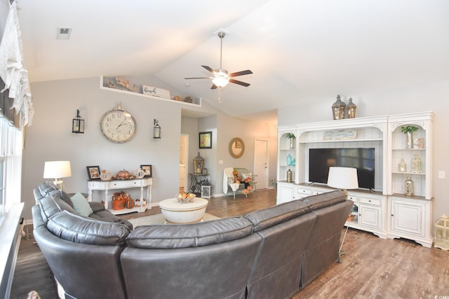 living room featuring ceiling fan, wood-type flooring, and vaulted ceiling