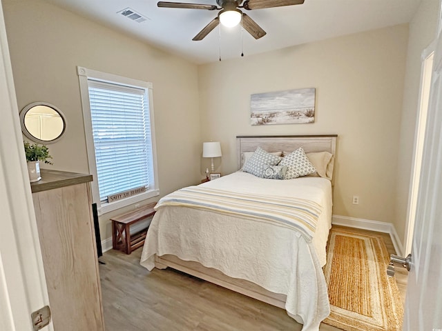 bedroom with light hardwood / wood-style floors and ceiling fan