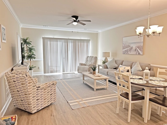 living room with hardwood / wood-style floors, ceiling fan with notable chandelier, and crown molding