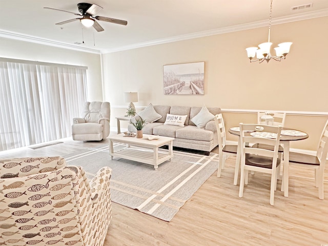 living room featuring ornamental molding, ceiling fan with notable chandelier, and hardwood / wood-style flooring