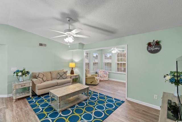 8546 Hopkins Cir Unit G, Surfside Beach, SC 29575 - living area with wood finished floors, a ceiling fan, baseboards, a textured ceiling, and vaulted ceiling