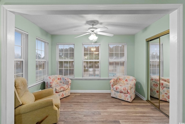 8546 Hopkins Cir Unit G, Surfside Beach, SC 29575 - sunroom featuring wood finished floors, baseboards, and a textured ceiling