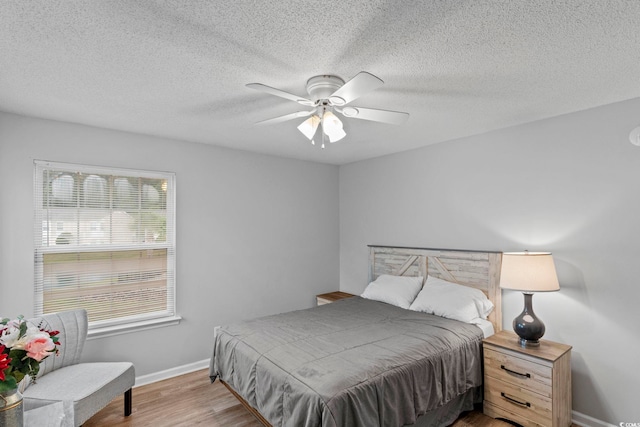 8546 Hopkins Cir Unit G, Surfside Beach, SC 29575 - bedroom featuring wood finished floors, baseboards, a ceiling fan, and a textured ceiling