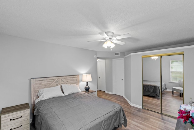 8546 Hopkins Cir Unit G, Surfside Beach, SC 29575 - bedroom featuring wood finished floors, a textured ceiling, a closet, a ceiling fan, and baseboards