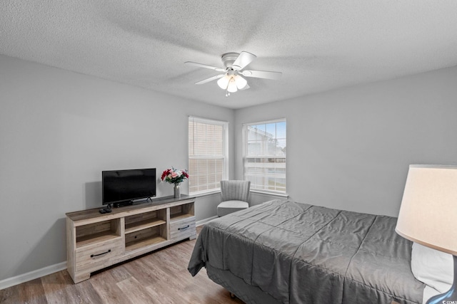 8546 Hopkins Cir Unit G, Surfside Beach, SC 29575 - bedroom with wood finished floors, baseboards, a textured ceiling, and ceiling fan