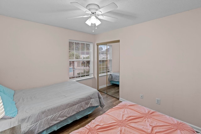 8546 Hopkins Cir Unit G, Surfside Beach, SC 29575 - bedroom featuring wood finished floors, a closet, baseboards, ceiling fan, and a textured ceiling