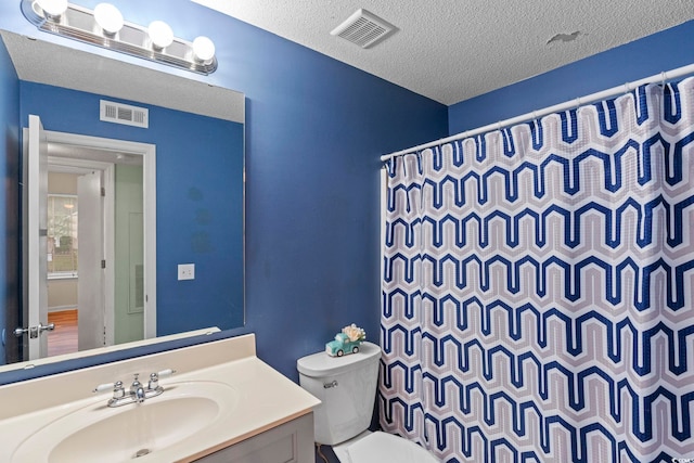 8546 Hopkins Cir Unit G, Surfside Beach, SC 29575 - bathroom featuring toilet, curtained shower, vanity, and a textured ceiling