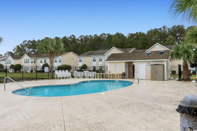 8546 Hopkins Cir Unit G, Surfside Beach, SC 29575 - community pool with a patio, fence, an outbuilding, and a residential view