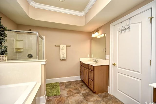 bathroom with a tray ceiling, vanity, crown molding, and plus walk in shower