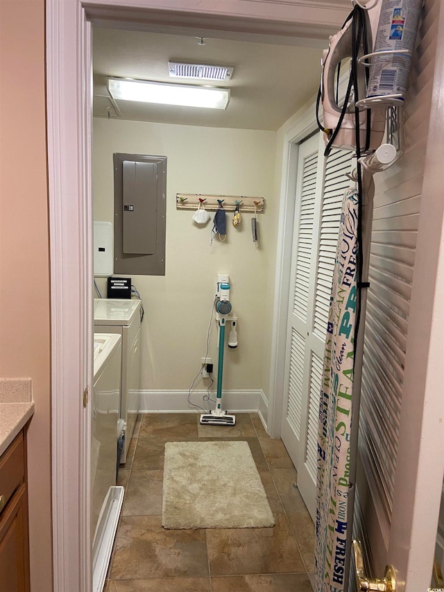 bathroom with electric panel, vanity, and washing machine and clothes dryer