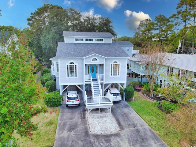 beach home with a porch and a carport