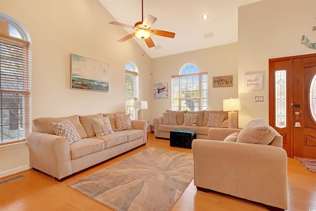 living room featuring high vaulted ceiling, ceiling fan, and light hardwood / wood-style floors