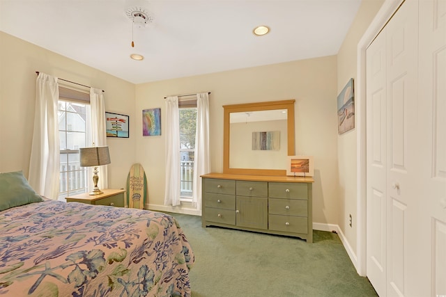 bedroom featuring multiple windows, a closet, and carpet floors