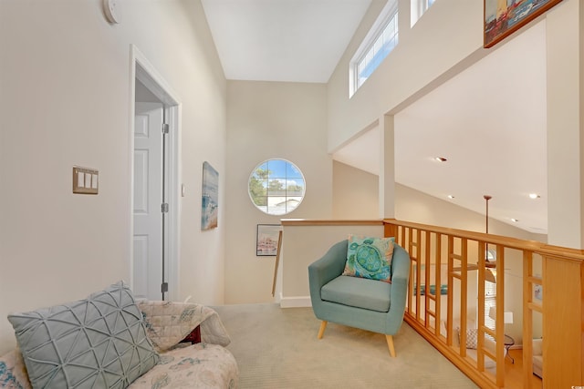 sitting room featuring high vaulted ceiling, a wealth of natural light, and carpet floors