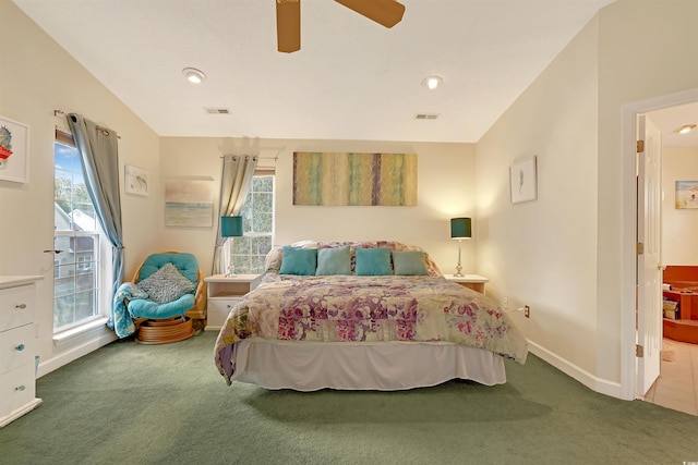 bedroom with ceiling fan, multiple windows, and carpet floors