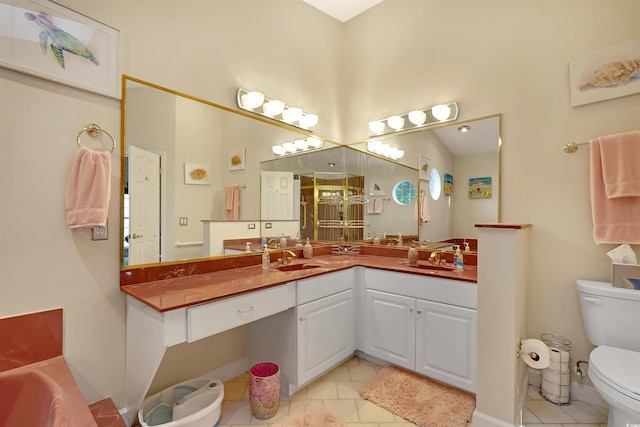 bathroom featuring toilet, vanity, and tile patterned flooring