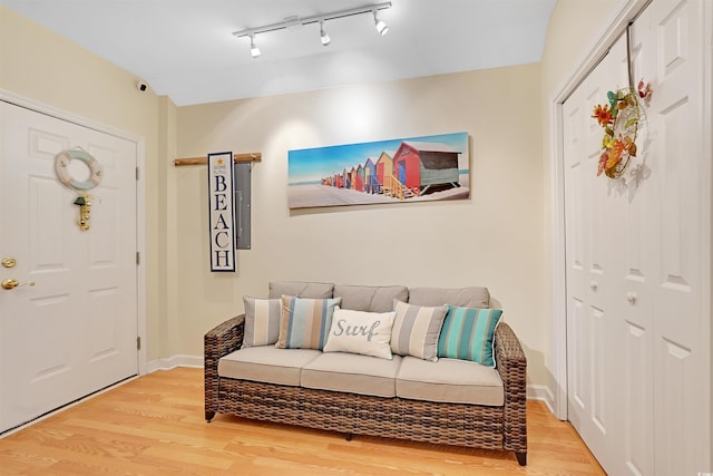 entrance foyer with hardwood / wood-style floors and rail lighting