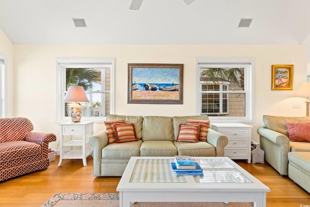 living room featuring light wood-type flooring and ceiling fan