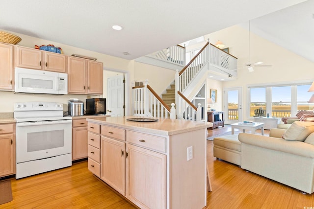 kitchen with light wood-type flooring, light brown cabinetry, white appliances, and high vaulted ceiling