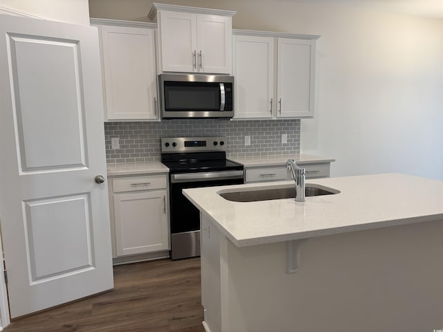 kitchen featuring sink, white cabinets, dark wood-type flooring, and appliances with stainless steel finishes