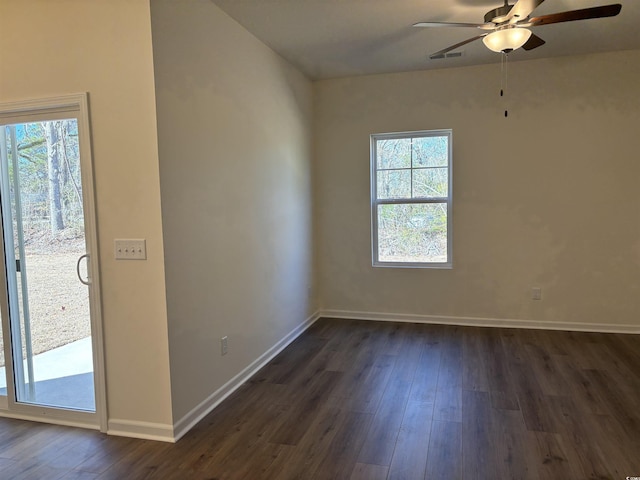 spare room featuring ceiling fan and dark wood-type flooring