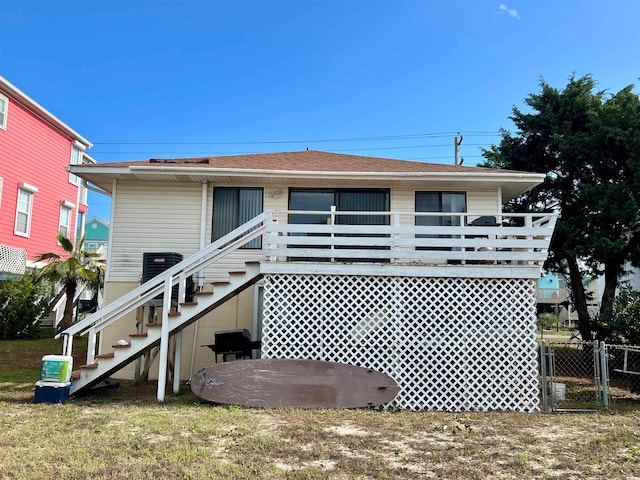 back of property with a lawn and cooling unit