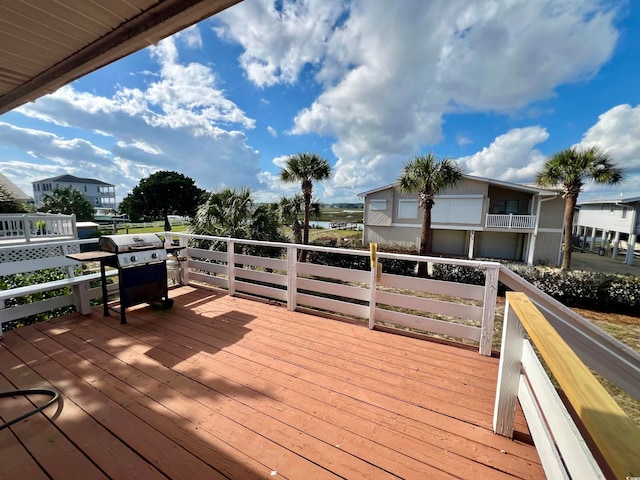 wooden deck with a grill