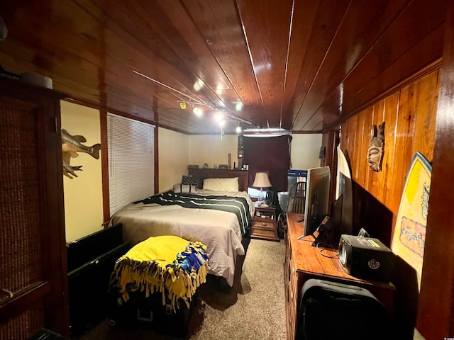 carpeted bedroom with wooden walls and wooden ceiling