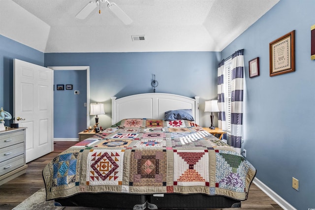 bedroom with vaulted ceiling, wood finished floors, a textured ceiling, a ceiling fan, and baseboards