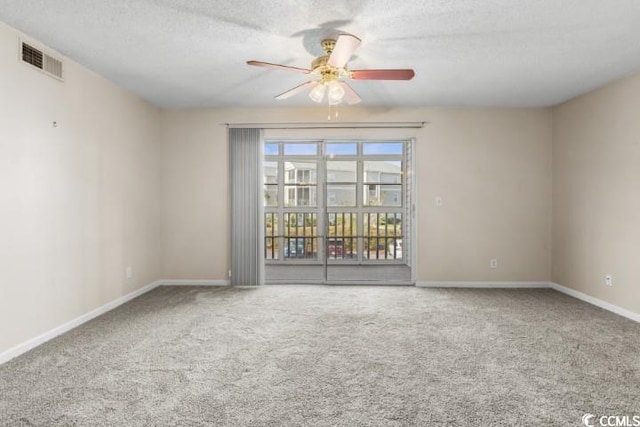 carpeted empty room featuring a textured ceiling and ceiling fan