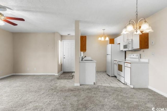 kitchen featuring ceiling fan with notable chandelier, white cabinets, light carpet, white appliances, and decorative light fixtures