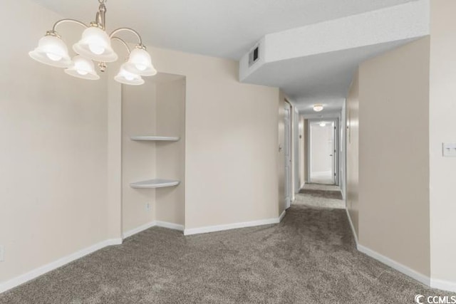 interior space featuring dark colored carpet and an inviting chandelier