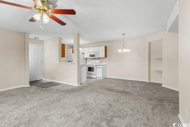 unfurnished living room with ceiling fan with notable chandelier and light carpet